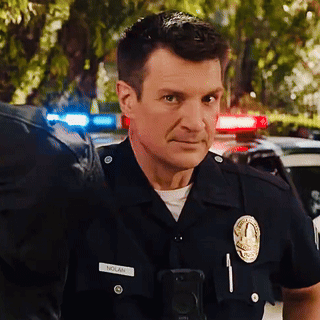 A Man In A Police Uniform Has The Name Nolan On His Badge GIF