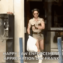 A Man In A Police Uniform Is Carrying A Trash Bag And A Cell Phone . GIF