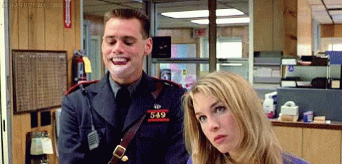 A Man In A Police Uniform Is Laughing While Standing Next To A Woman In A Room . GIF