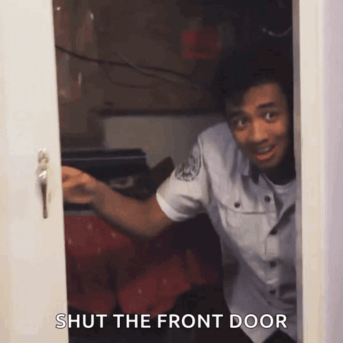 A Man In A Police Uniform Is Peeking Out Of A Door With The Words Shut The Front Door Below Him GIF