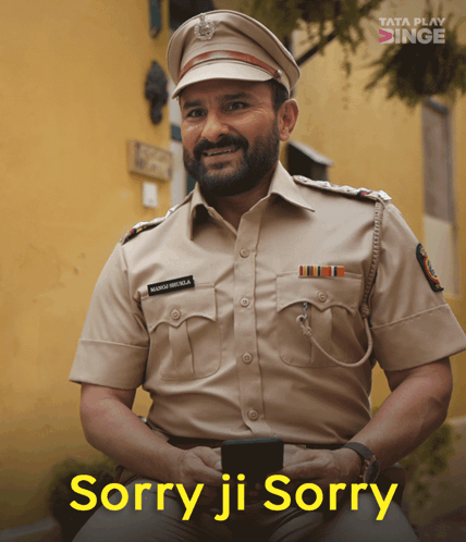 A Man In A Police Uniform Is Smiling With The Words Sorry Ji Sorry Above Him GIF