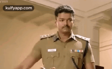 A Man In A Police Uniform Is Standing In A Room And Talking To Someone . GIF