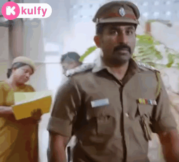 A Man In A Police Uniform Is Standing In Front Of A Woman Holding A Yellow Folder . GIF