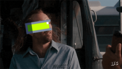 A Man In A Prison Uniform Has A Green Block On His Eye GIF