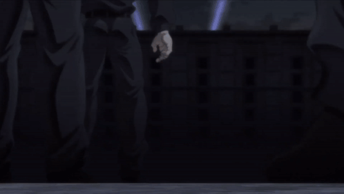 A Man In A Prison Uniform Is Laying On His Back In The Dark GIF