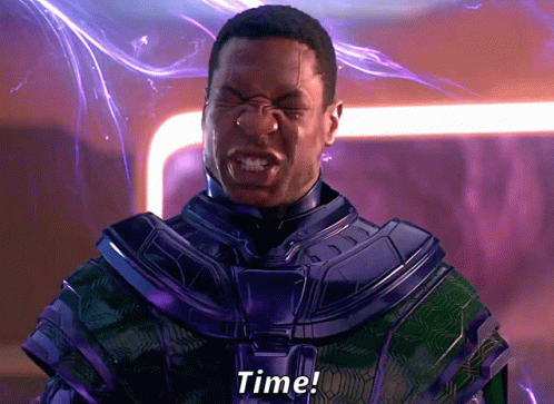 A Man In A Purple And Green Suit Is Screaming The Word Time GIF