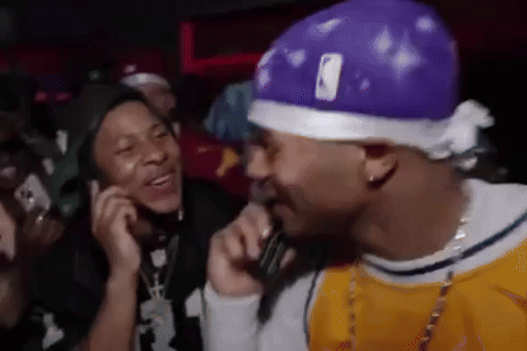 Man In Purple Hat Talking Into Microphone GIF