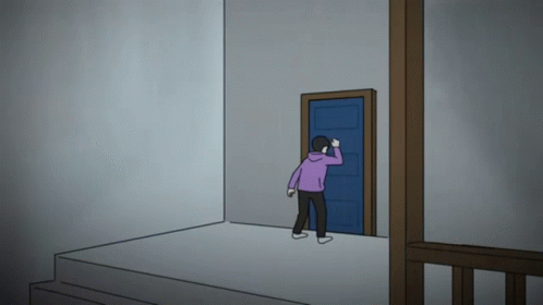 a man in a purple hoodie is standing in front of a door
