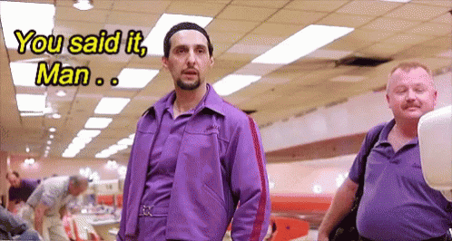 A Man In A Purple Jacket Is Talking To Another Man GIF