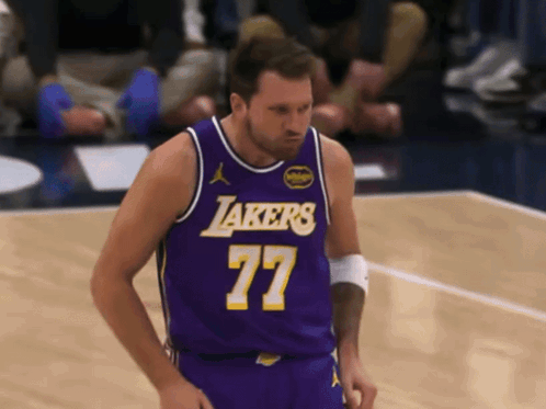 A Man In A Purple Lakers Jersey Stands On The Court GIF