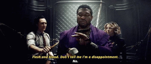 A Man In A Purple Robe Is Holding A Hammer And Talking To A Group Of People In A Dark Room . GIF