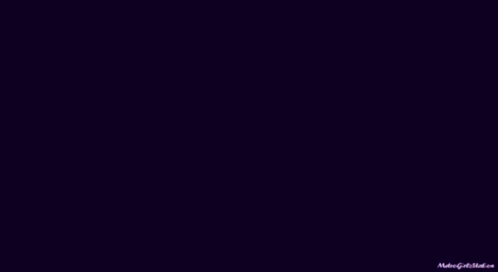 A Man In A Purple Shirt And Tie Has A Tattoo On His Wrist . GIF
