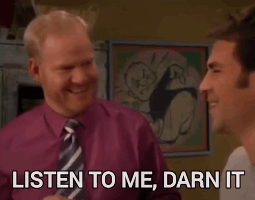 A Man In A Purple Shirt And Tie Is Talking To Another Man Who Says Listen To Me Darn It GIF