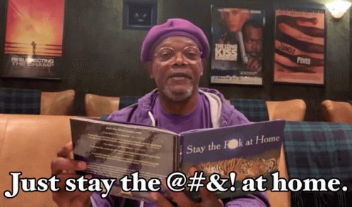 A Man In A Purple Shirt Holds A Book That Says Just Stay The @ # & ! At Home GIF