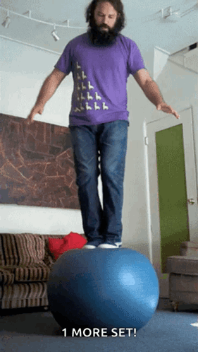 A Man In A Purple Shirt Is Balancing On A Blue Ball With The Words " 1 More Set " Below Him GIF