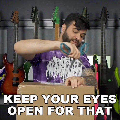 A Man In A Purple Shirt Is Cutting A Cardboard Box With The Words " Keep Your Eyes Open For That " GIF