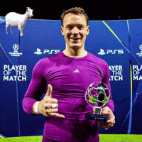a man in a purple shirt is holding a trophy and giving a thumbs up sign
