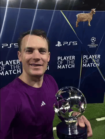a man in a purple shirt is holding a trophy in front of a sign that says ps5 player of the match