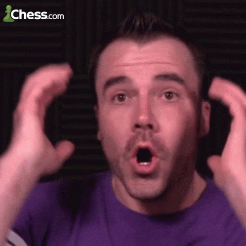 A Man In A Purple Shirt Is Making A Surprised Face With Chess.com In The Background GIF
