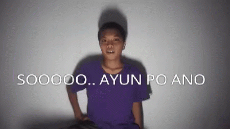 A Man In A Purple Shirt Is Standing In Front Of A Wall That Says S00000 Ayun Po Ano GIF