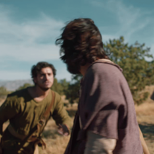 A Man In A Purple Shirt Is Standing Next To Another Man GIF