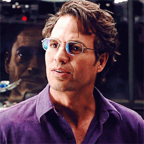 A Man In A Purple Shirt Is Wearing Glasses GIF