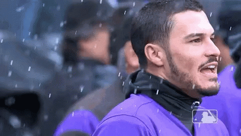 A Man In A Purple Shirt With A Mlb Logo On His Shirt GIF