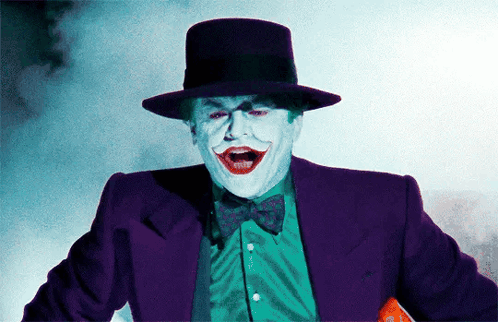 A Man In A Purple Suit And Top Hat Is Making A Funny Face GIF