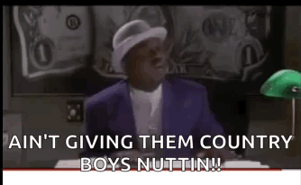 A Man In A Purple Suit And White Hat Is Sitting At A Desk In Front Of A Green Lamp . GIF
