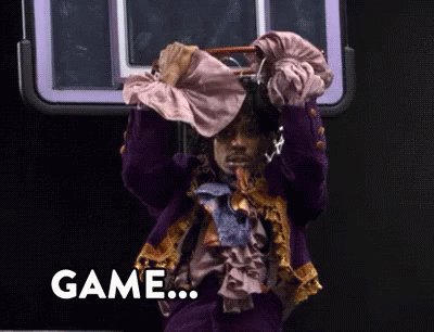 A Man In A Purple Suit Is Holding A Purse Over His Head And The Word Game Is On The Bottom Right GIF