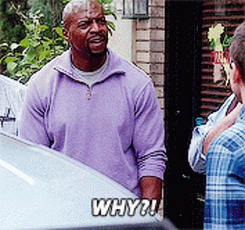 A Man In A Purple Sweater Is Talking To A Man In A Plaid Shirt GIF