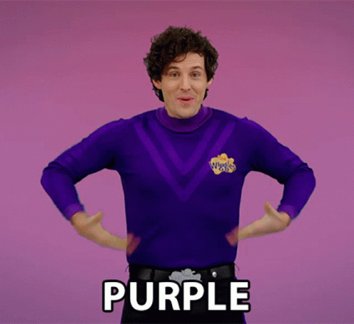A Man In A Purple Sweater With The Word Purple Written On The Bottom GIF
