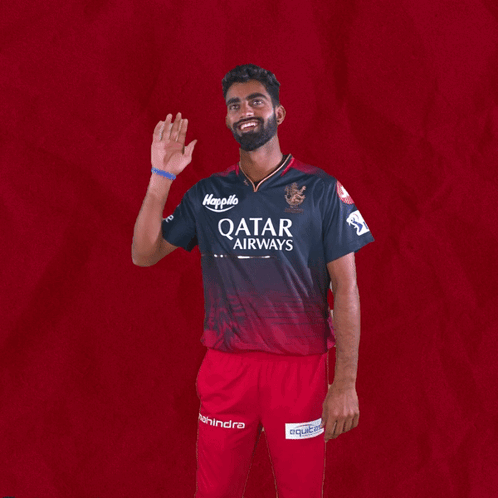 A Man In A Qatar Airways Shirt Waves His Hand GIF