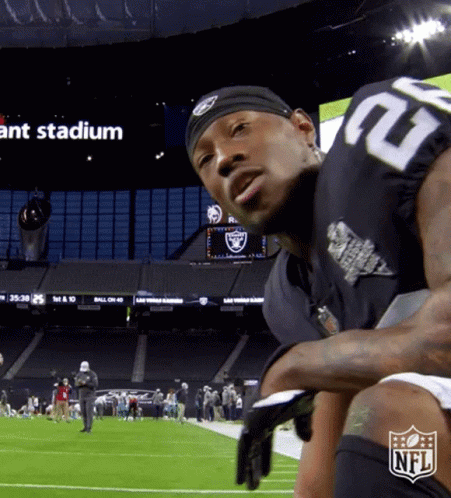 A Man In A Raiders Jersey Stands On A Football Field GIF