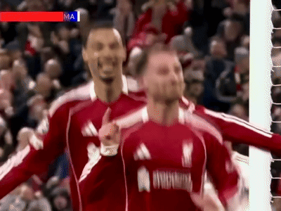 A Man In A Red Adidas Jersey Is Giving A Thumbs Up In Front Of A Crowd GIF