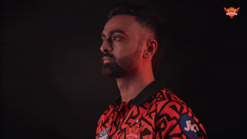 A Man In A Red And Black Shirt With Jio On His Arm GIF