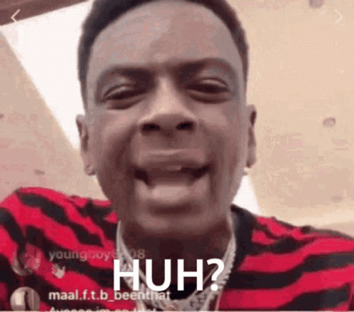 A Man In A Red And Black Striped Shirt Is Making A Funny Face And Says Huh ? GIF