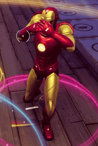 a man in a red and gold superhero suit is standing on a wooden floor