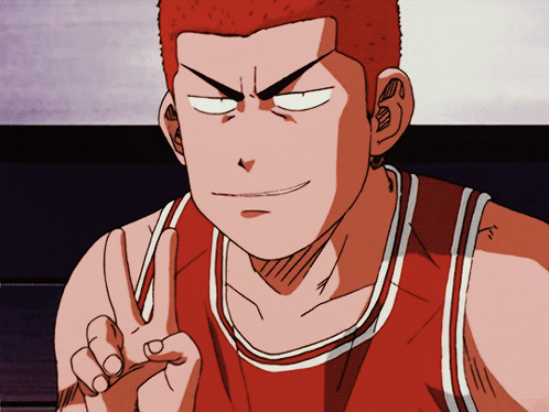 A Man In A Red And White Basketball Jersey Giving A Peace Sign GIF