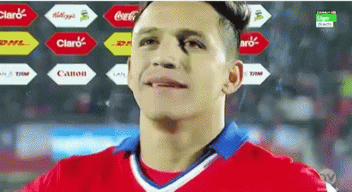 A Man In A Red And White Jersey With A Coca Cola Logo In The Background GIF