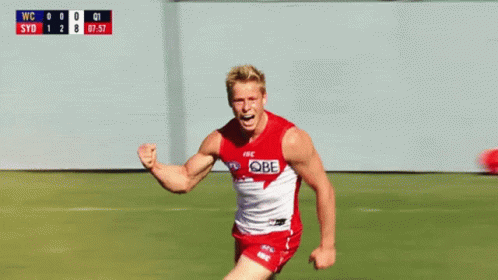 A Man In A Red And White Jersey With The Word Sydney On It Is Running On A Field GIF