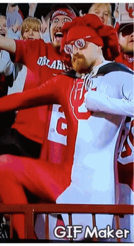 A Man In A Red And White Outfit With The Letter G On It GIF