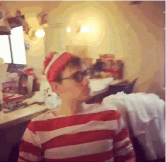 A Man In A Red And White Striped Shirt Is Wearing A Red Hat And Sunglasses GIF