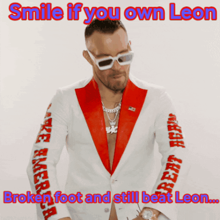 A Man In A Red And White Suit With The Caption Smile If You Own Leon GIF