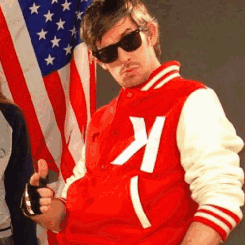 A Man In A Red And White Varsity Jacket With The Letter K On It GIF