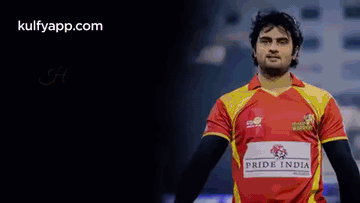 a man in a red and yellow jersey with the word pride india on it