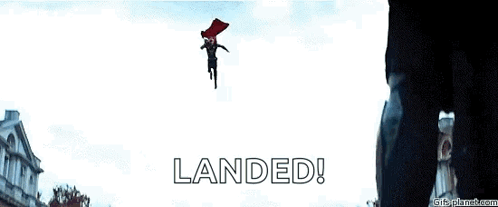 A Man In A Red Cape Is Flying Through The Air With The Words Landed Written Below Him . GIF
