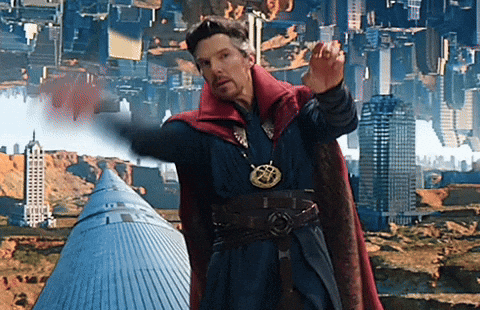 A Man In A Red Cape Is Standing In Front Of A City With Buildings Upside Down GIF