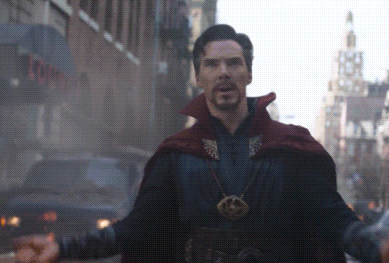 A Man In A Red Cape Stands In Front Of A Building That Says ' Tower ' On It GIF