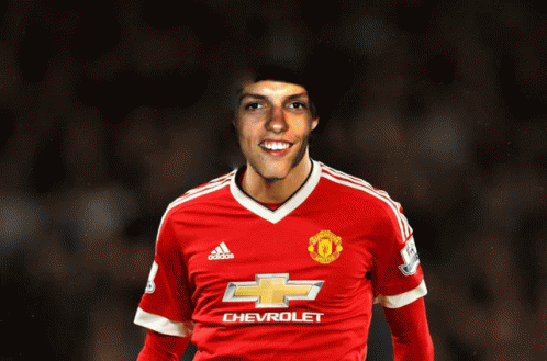 a man in a red chevrolet jersey smiles